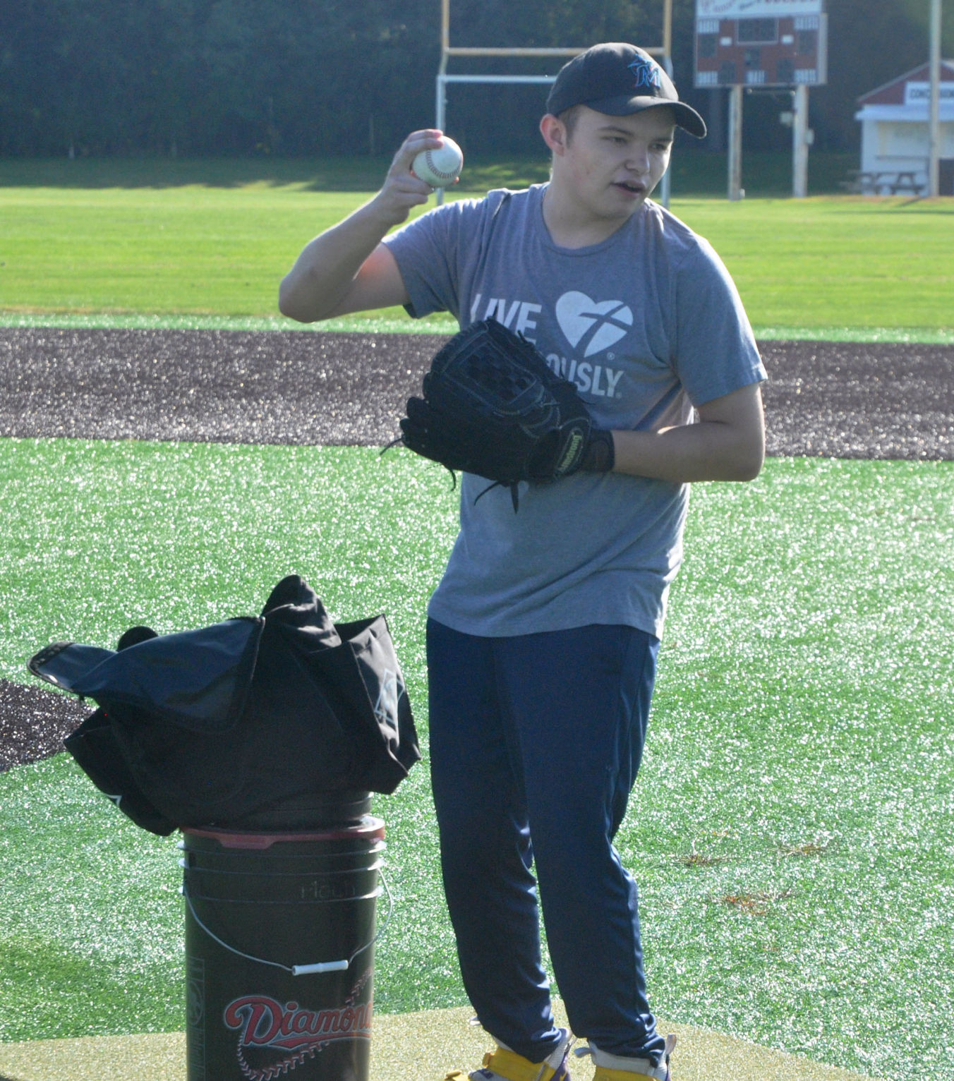After receiving his new electric bike, Badger High School student Brooks Guif practices his pitching